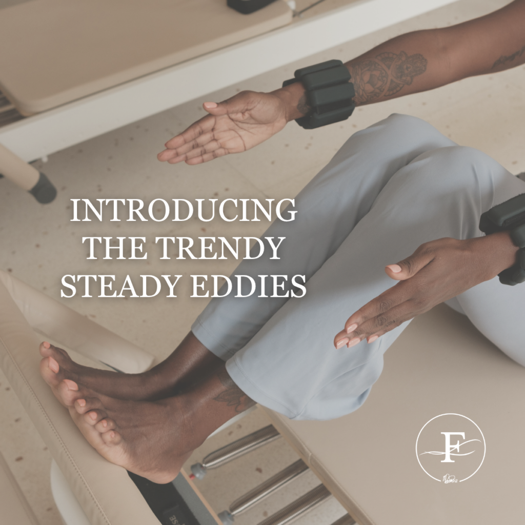 Woman sitting on a workout reformer with ankle weights, legs extended, and hands outstretched, with the text “Introducing the Trendy Steady Eddies” overlaid.
